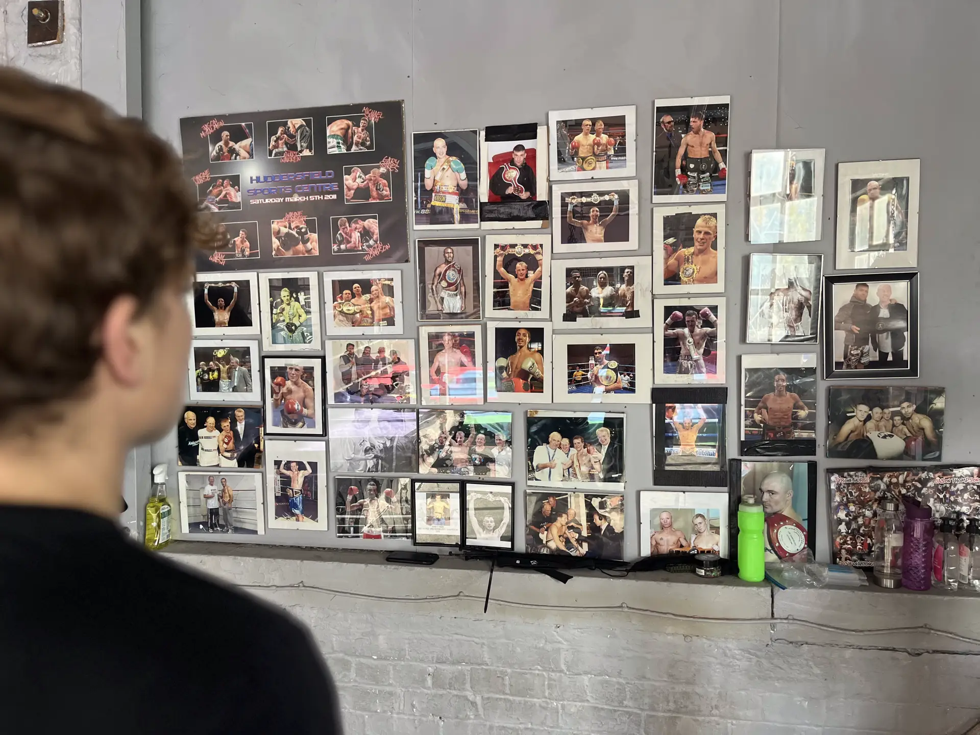 A wall of framed image of the legacy of past boxers from Aston Boxing Club