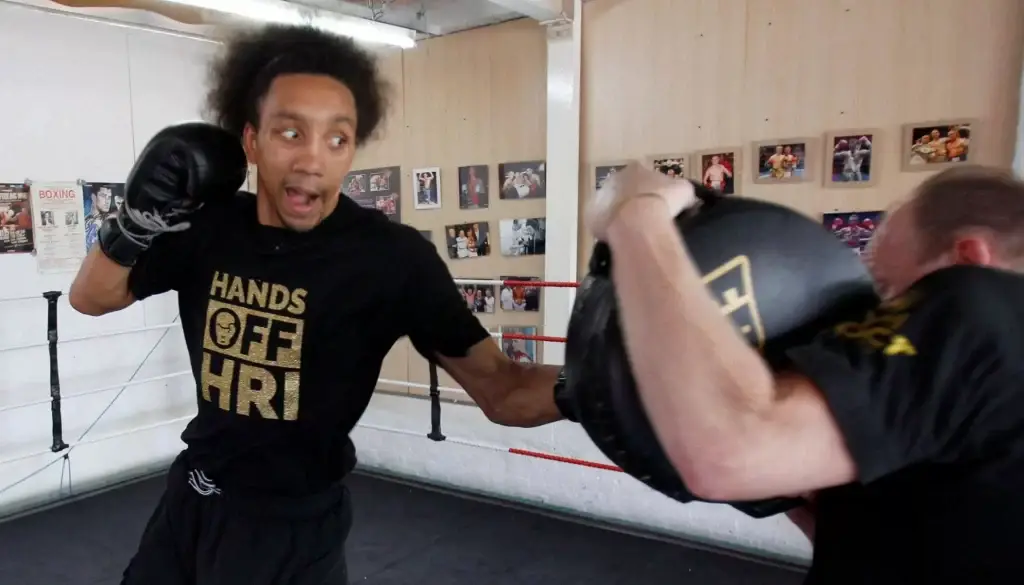 Tyrone Nurse hitting pads with Chris Aston inside Aston boxing club